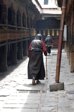 Tibetan woman rotating the prayer wheels... always moving clockwise!