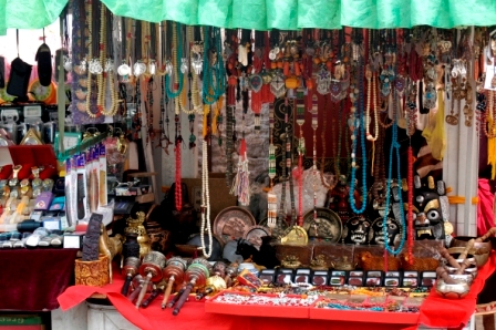 Stands selling prayer wheels, rosaries, necklaces and other objects at flee market in Barkhor Square