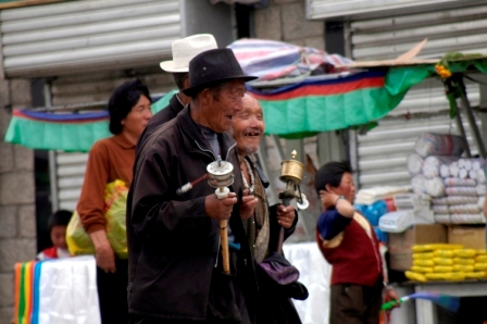 Tibetan man rotating his prayer wheel