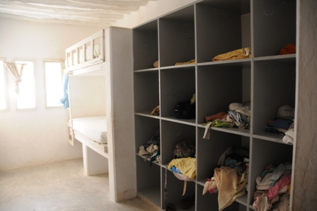 The rooms with the boxes to keep the children's things. Each room sleeps 8 children